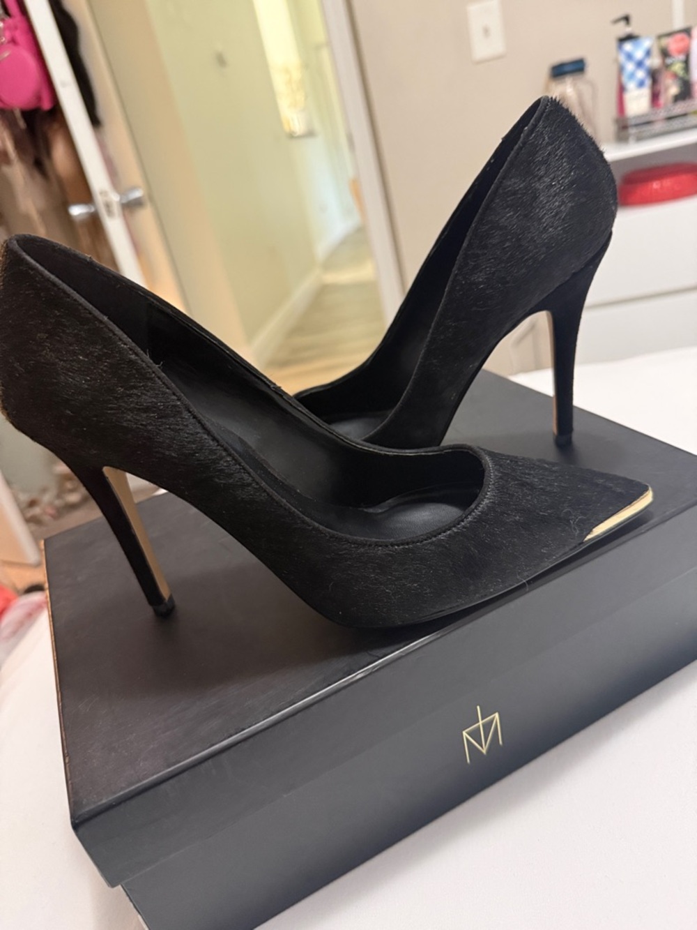Black Pointed-Toe Stiletto Pumps with Subtle Gold Toe Detail
